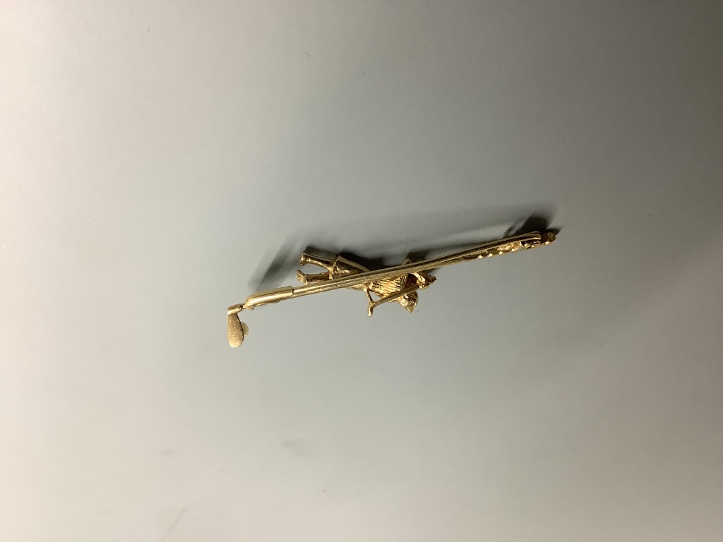 A modern 9ct gold and seed pearl set bar brooch, modelled as a golfer and golf club, 56mm, gross 4.8 grams.